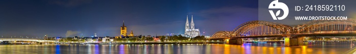 Panorama of cologne with the Hohenzollern Bridge over the Rhine River and Cologne Cathedral by night