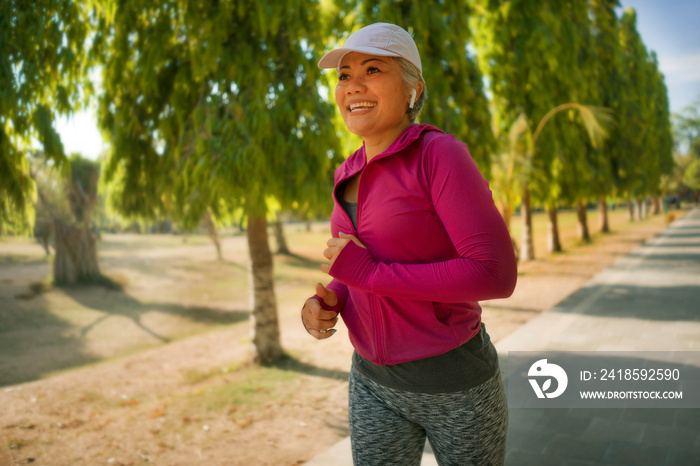 attractive middle aged lady running happy at city park . beautiful and sporty woman on her 40s exerc