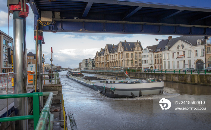 Barge at river Schelde Belgium. Oudenaarde. Freight boat. Inland shipping. Hydraulic bridge.