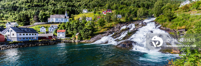 Panorama of small village Hellesylt with Hellesyltfossen waterfall in along Geiranger fjord in More 