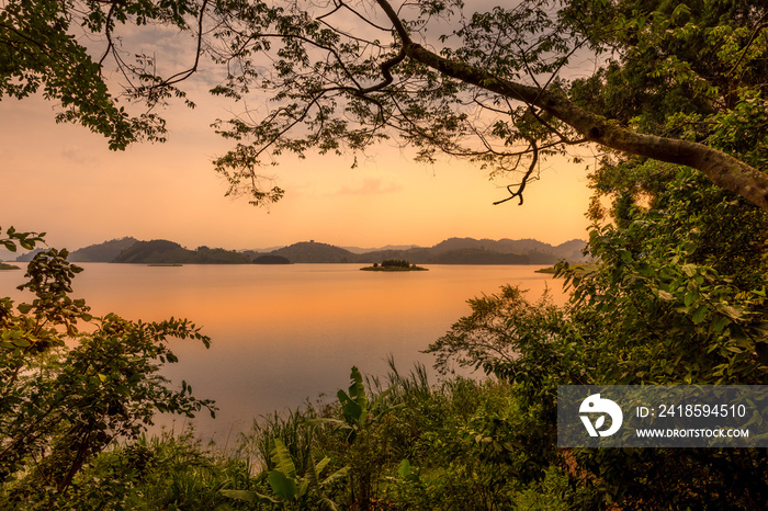 Lake Mutanda at sunset with view on the volcanoes mount Muhavuru and mount Gahinga in East Africa, a