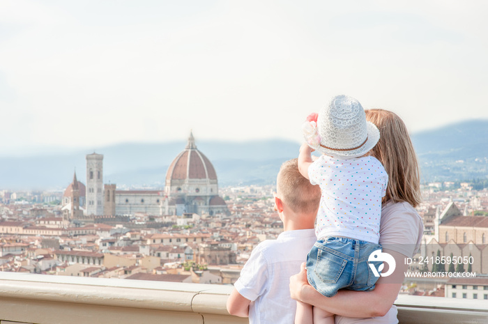 Family traveling. Woman with kids looking on panoramic view of florence, Italy