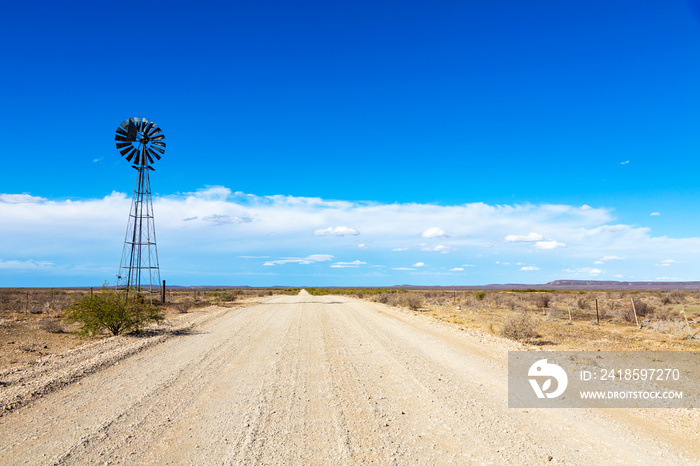 Windpump next to the gravel road in the Karoo