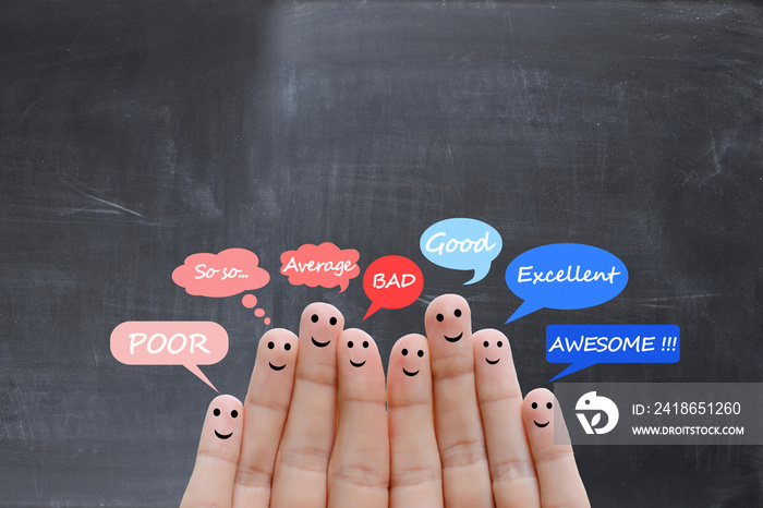 Customer satisfaction scale and testimonials concept with happy human fingers on a blackboard