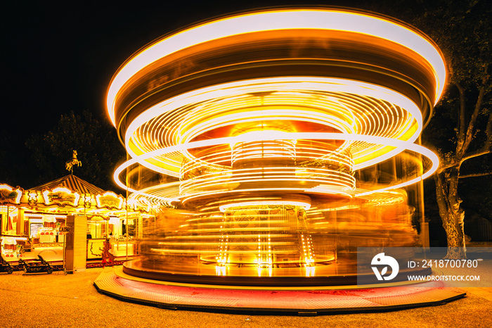 Brightly illuminated traditional carousel in Paris France at night...