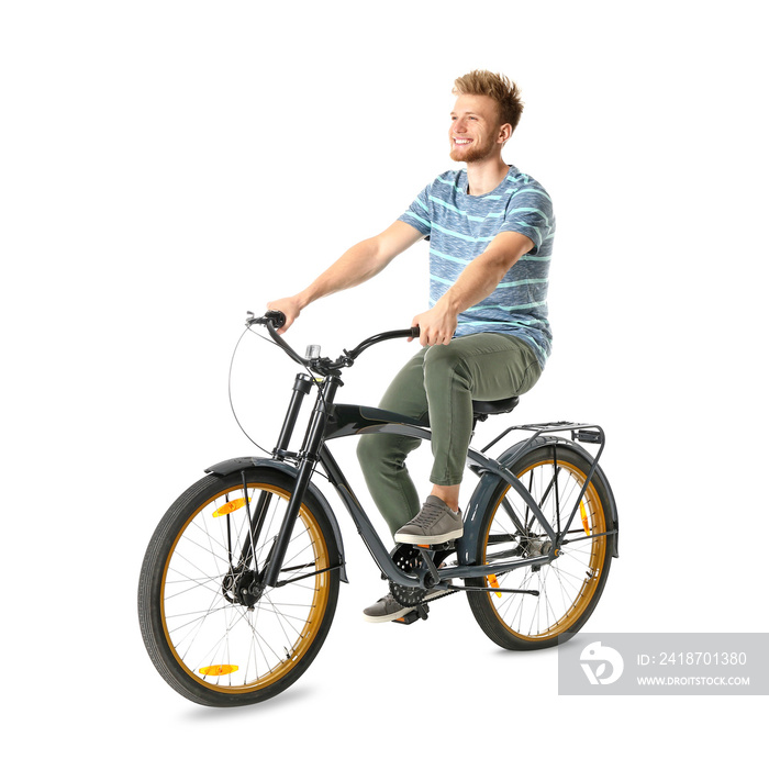 Young man riding bicycle against white background