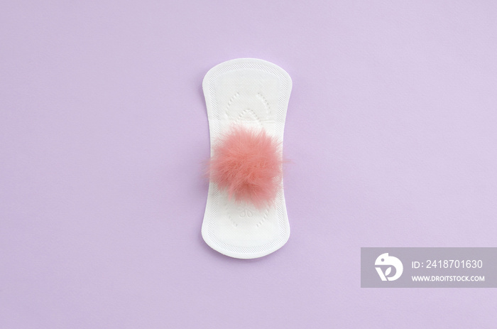 Menstrual pad and red fluffy fuzzy as a blood on violet pastel background flat lay top view