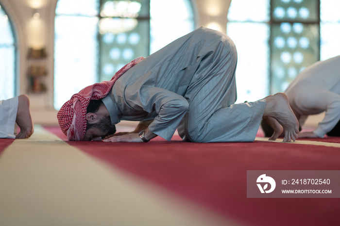 group of muslim people praying namaz in mosque.