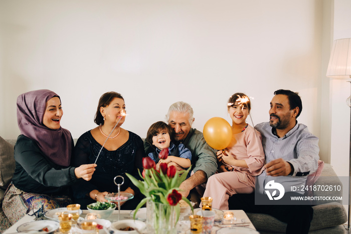 Multi-generation cheerful family celebrating birthday party at home