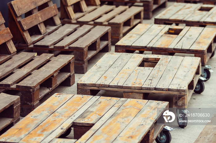 Empty wooden pallet in loft interior with grunge walls. Decor of wooden pallets