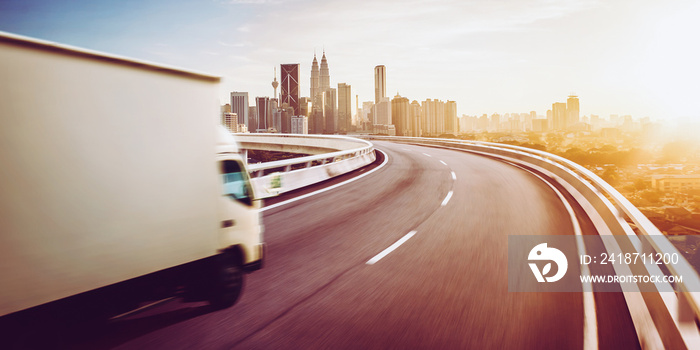 Truck traveling on road at sunrise - speed and delivery concept.