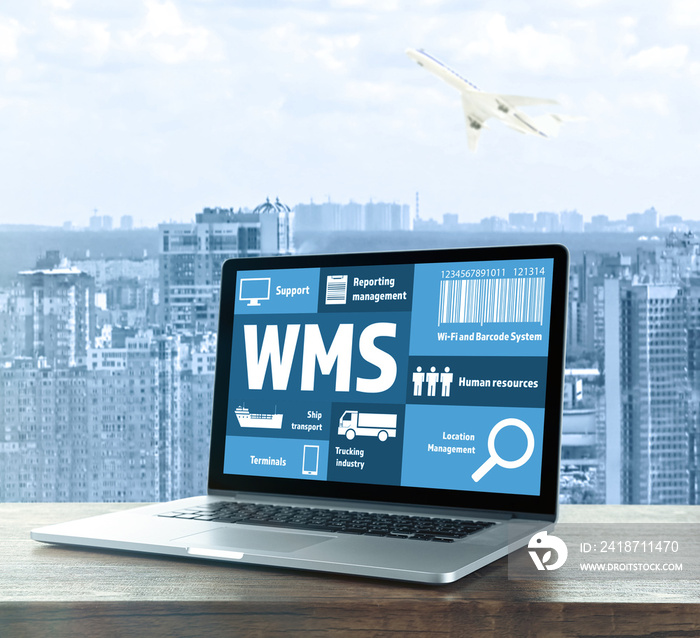 Warehouse management system concept. Laptop on table against cityscape background