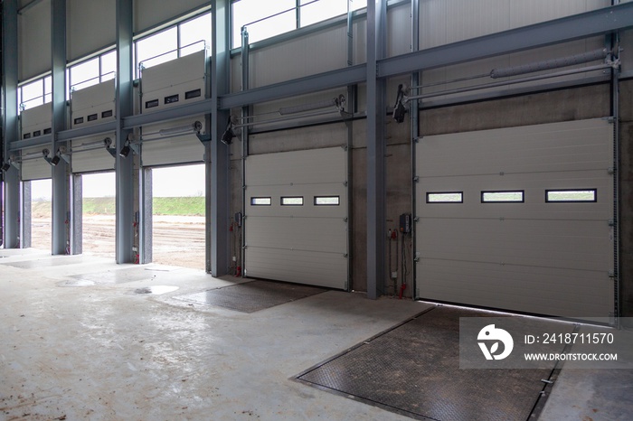 Row of loading bays in a warehouse with open and closed doors