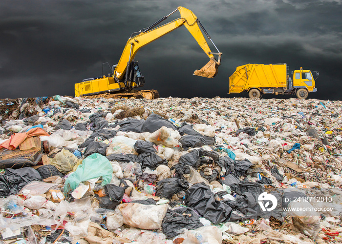 garbage dump pile in trash dump or landfill,backhoe and truck is dumping the gabage from municipal,g