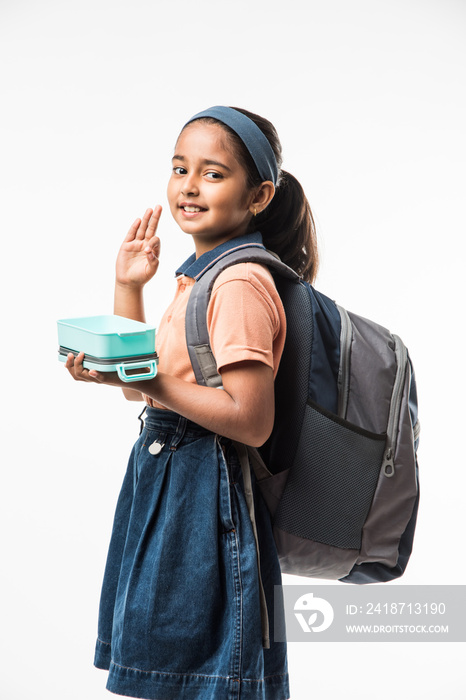 Indian girl in school uniform, standing isolated over white background ready to leave