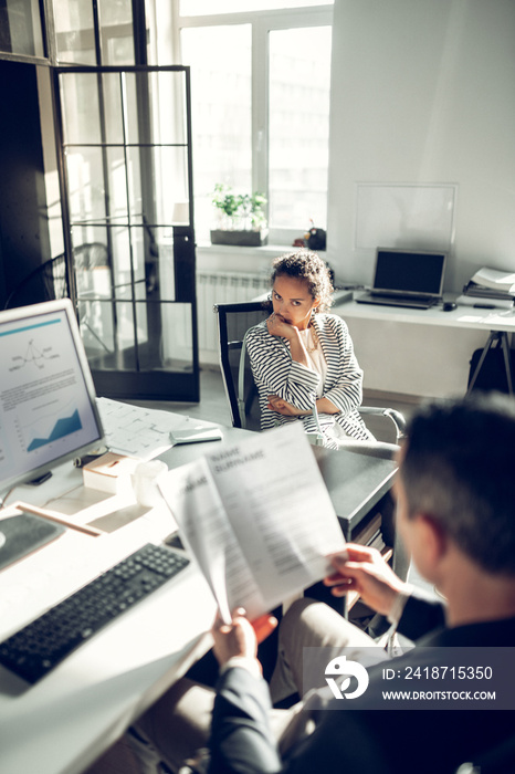 Young woman feeling uncomfortable during job interview