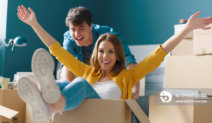 Cheerful young couple moving in their new house