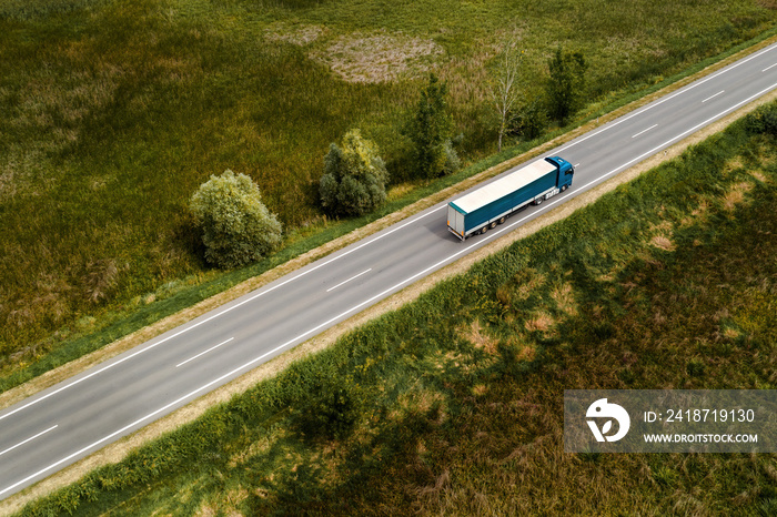 Large freight transporter semi-truck on the road, aerial view