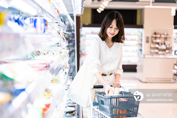 スーパーで食料品を買う若い女性