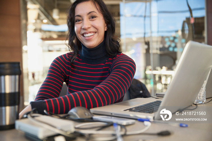 Portrait of pretty businesswoman smiling at her desk.