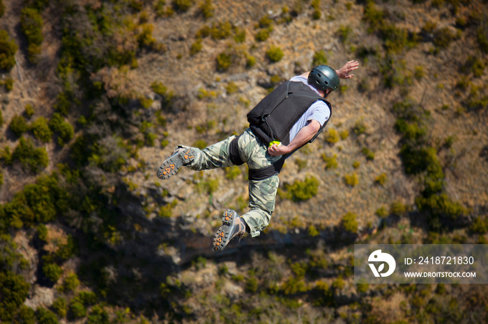 Rear view of man BASE jumping