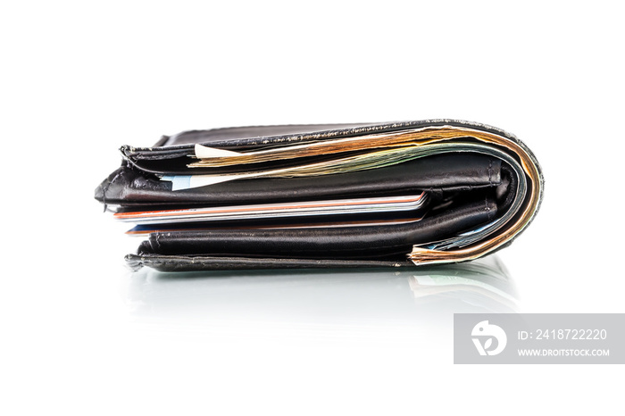 Wallet full of banknotes and credit cards isolated on white with mirror reflection.