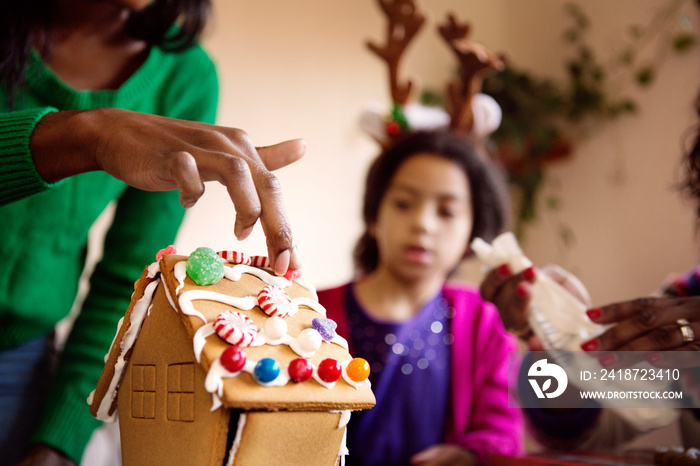 Girl (4-5) looking at cottage shape cake