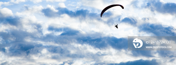 silhouette of skydiver with parachute - live your dream, freedom and adrenaline concept