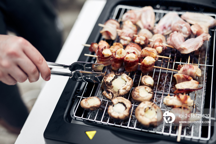 Preparing barbeque on a electrical modern grill outdoors.