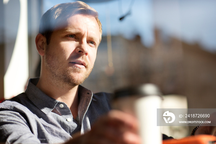 Man daydreaming in cafe