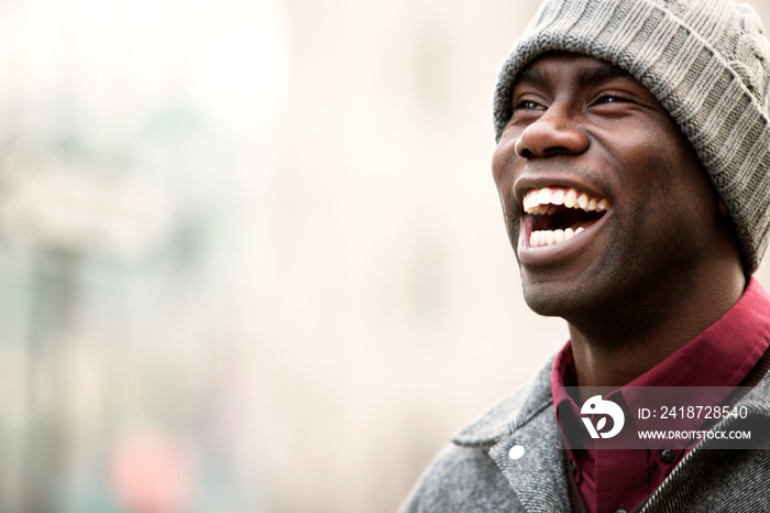 Portrait of man laughing outside