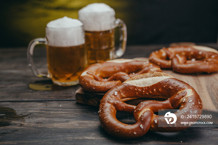 pretzels and beer on wooden table