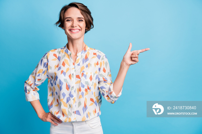 Photo of happy cheerful positive young woman point finger empty space isolated on pastel blue color 