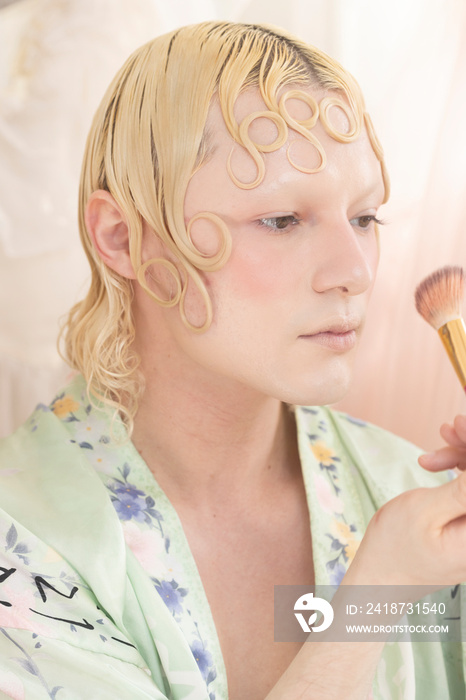 close up beauty of non-binary hispanic person applying makeup