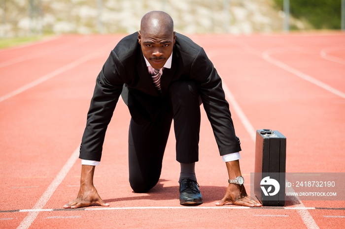 Businessman with briefcase ready to run