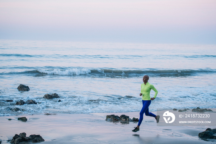 Young woman exercising, running, on beach