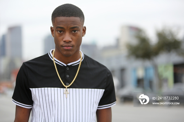 Street scene young African American male model against Dallas Texas skyline.