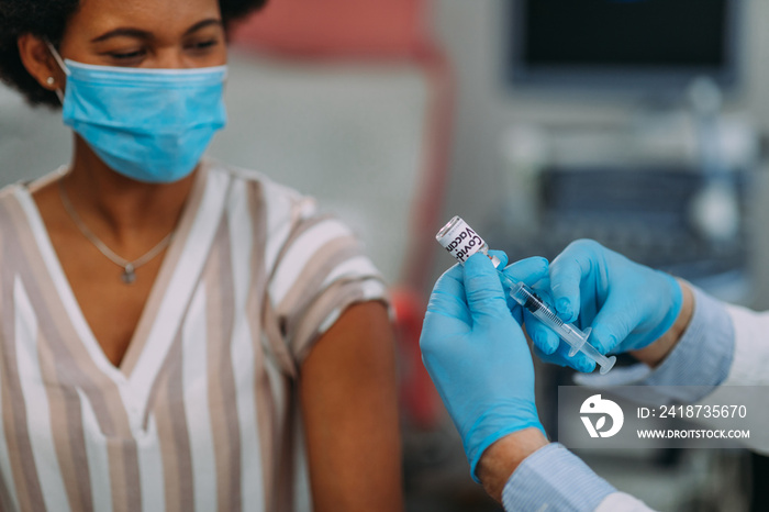 Doctor applying vaccine on patients arm