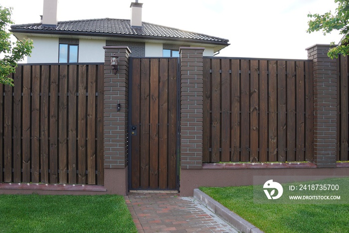 brown wooden plank fence and a closed door outside