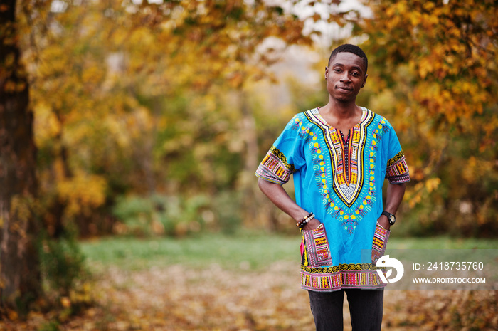 African man in africa traditional shirt on autumn park.