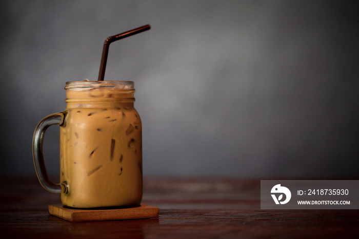 Iced Coffee Latte with Ice on Wood Table with space for text.