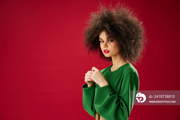 pretty woman in green dress afro hairstyle studio