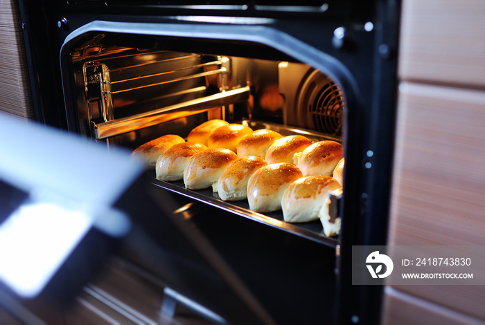 delicious hot yeast cakes with a Golden crust in a hot oven. Homemade cake.