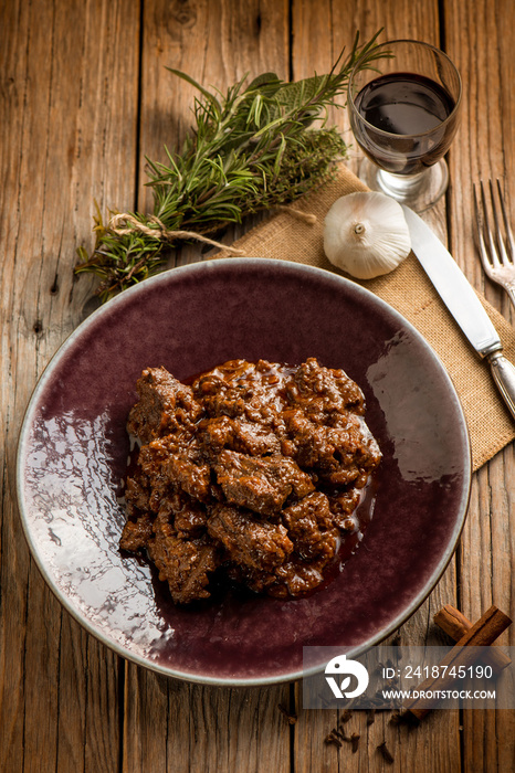 venison stew traditional italian recipe and glass of red wine