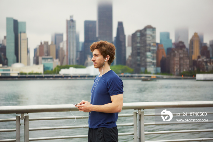 Side-view of jogger, city in background