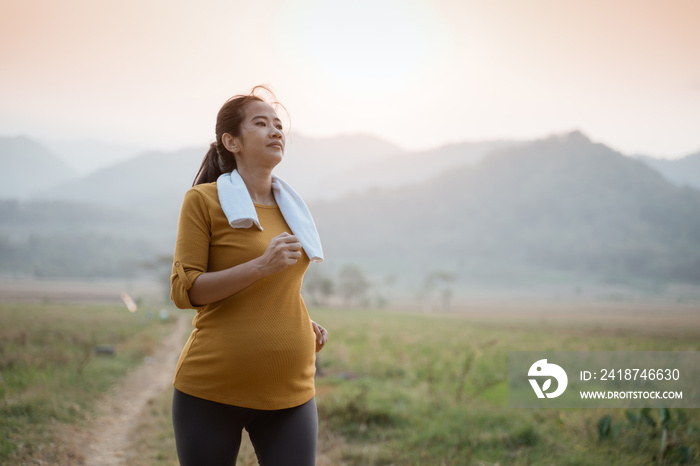 happy asian pregnant woman in her trimester workout outdoor