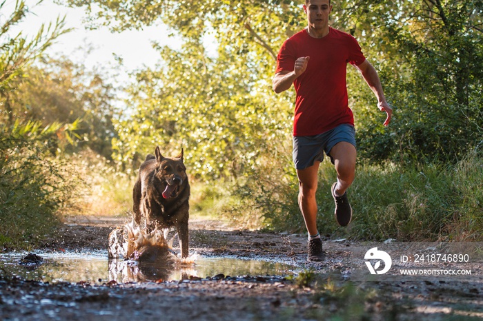 runner running across the field with his dog