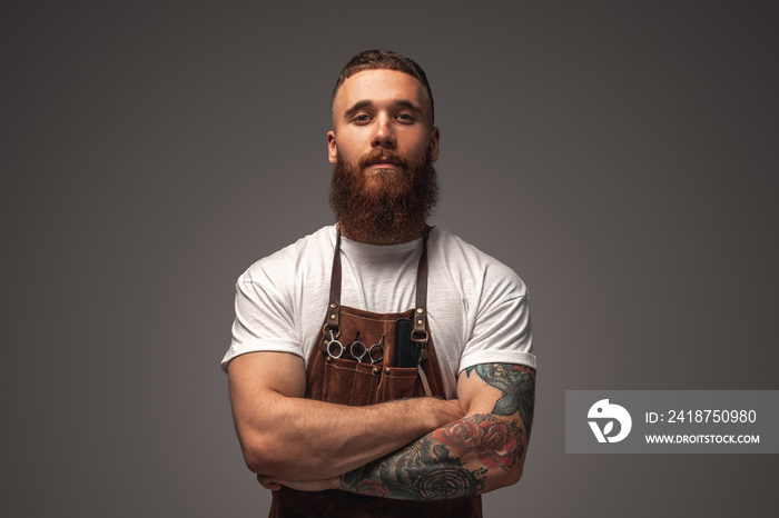 Confident tattooed hairdresser looking at camera