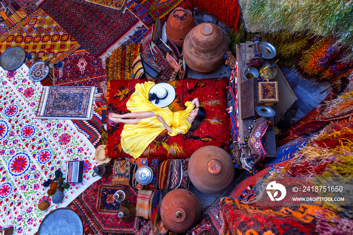 Beautiful girl at traditional carpet shop in Goreme city, Cappadocia in Turkey.