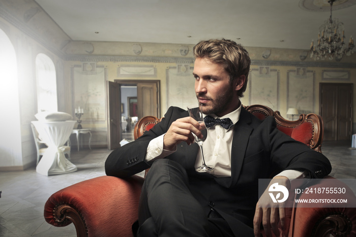 Handsome man drinking wine